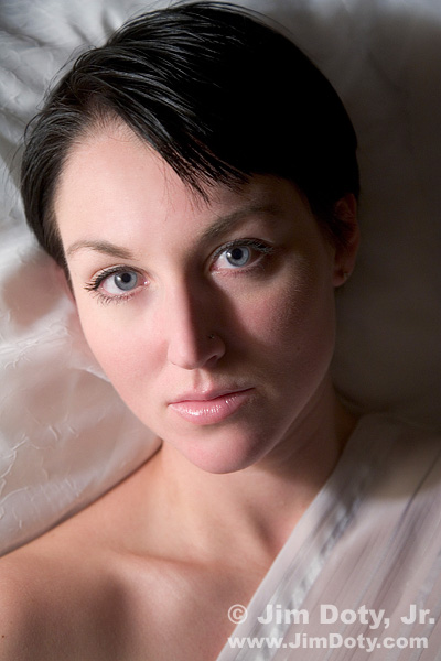 Portrait with a single household light bulb. Photo copyright Jim Doty Jr.