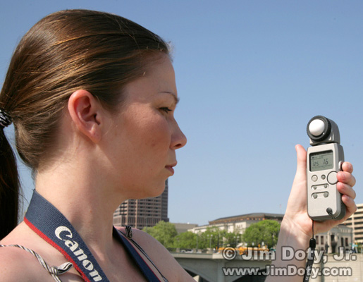 Photographer using an incident light meter. Photo copyright Jim Doty Jr.